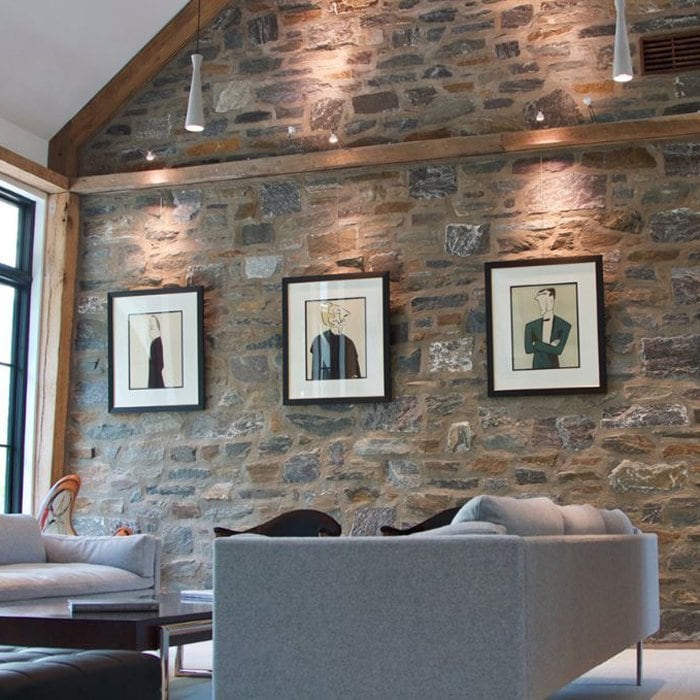 brick-wall-hang-pictures-hang-logic 3framed picture hung in a straight row on a stone wall