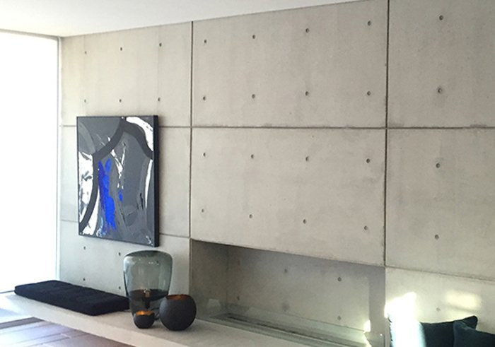 hang-pictures-concrete-wall-hang-logic blue painting hanging on concrete wall via art tracking