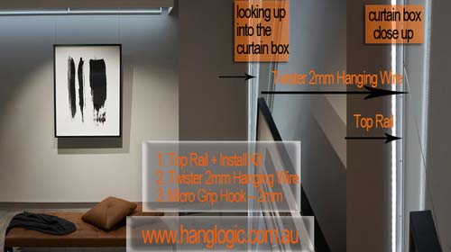 A picture hanging from a curtain box using the Artiteq Top Rail