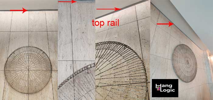 Round sculpted artwork hanging on wall with marble tiles