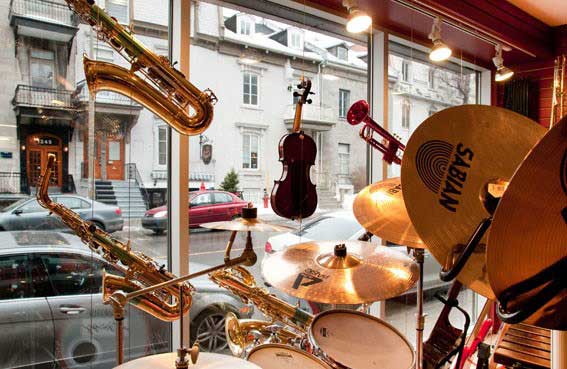 Musical instruments hanging from the ceiling in a shop window